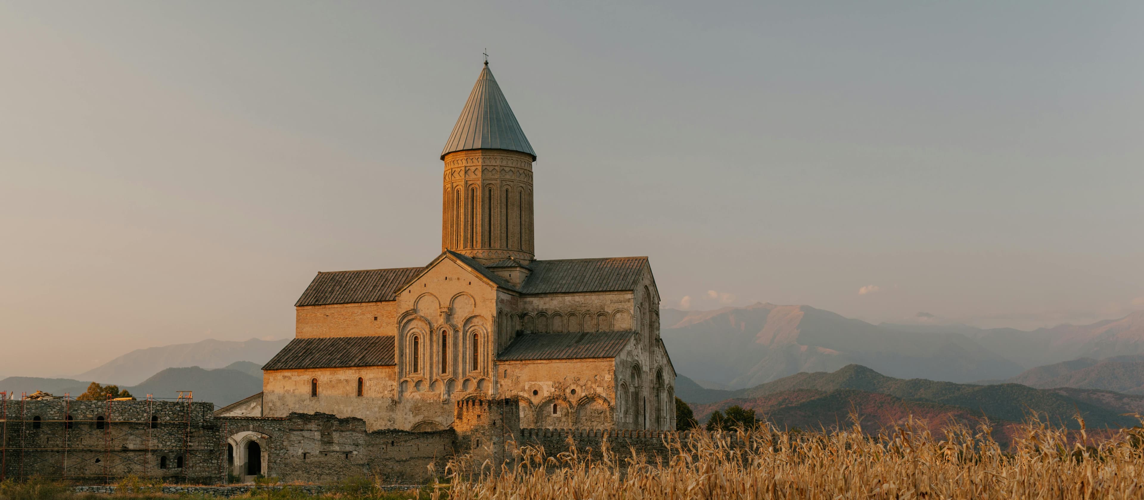 Historic Alaverdi Cathedral with distinctive Georgian architecture surrounded by Kakheti region vineyards and rolling hills