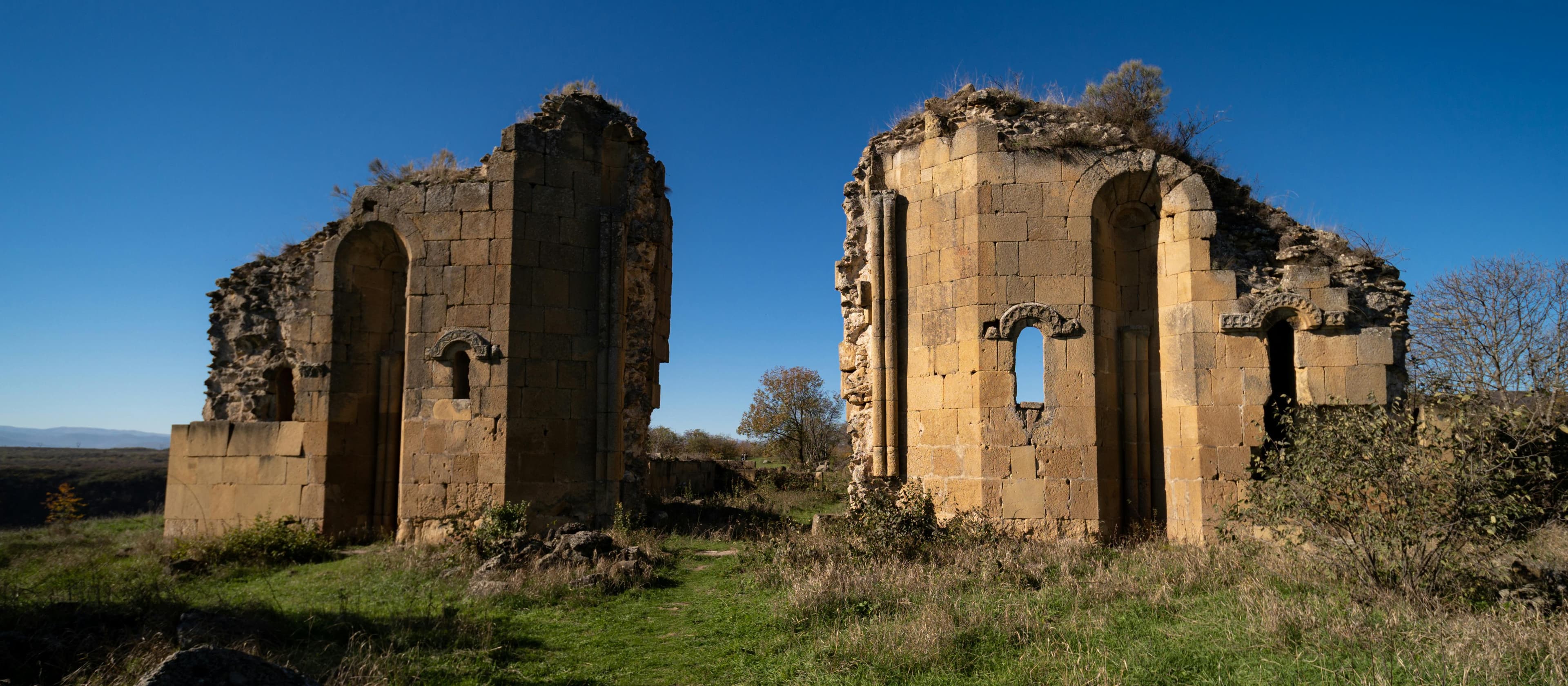 Ancient Samshvilde fortress ruins with medieval stone arches, weathered walls, and archaeological remains on dramatic plateau